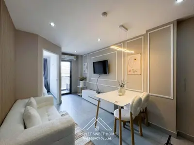 a living room with a couch and a table at Tower condo Rawai Phuket 305 in Ban Klang