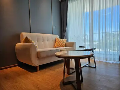 a living room with a couch and a table at La Vita Stylish apartment in 5 star hotel in Rawai Beach