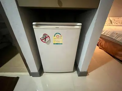 a small white trash can in a room with a bed at \u30a2\u30de\u30c6\u30e9\u30b9\u30d1\u30c8\u30f37 in Patong Beach