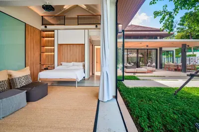 a bedroom in a house with a bed at Banyan Tree Grand Residences by Banyan Living in Phuket Town