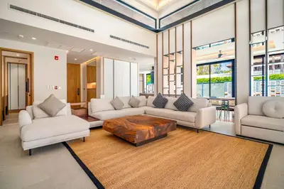 a living room with couches and a coffee table at Banyan Tree Grand Residences by Banyan Living in Phuket Town