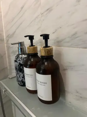 two bottles of honey sitting on a shelf at Oceana Kamala Stunning corner Suite Sea View in Kamala Beach