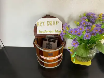 a jar of keys dip next to a vase of flowers at \u30d1\u30c8\u30f3\u30eb\u30fc\u30e07 in Patong Beach