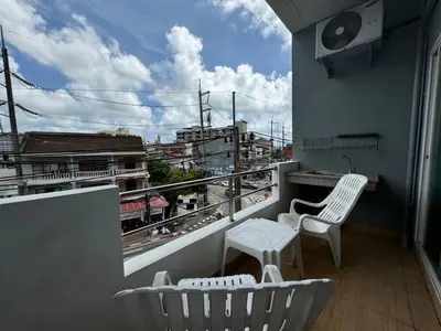 a balcony with two white chairs and a table at \u30d1\u30c8\u30f3\u30eb\u30fc\u30e07 in Patong Beach
