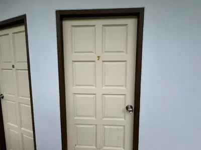 a white door with a black frame next to another door at \u30d1\u30c8\u30f3\u30eb\u30fc\u30e07 in Patong Beach