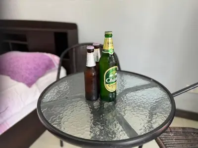 two bottles of beer sitting on a glass table at \u30d1\u30c8\u30f3\u30eb\u30fc\u30e01 in Patong Beach