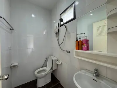 a white bathroom with a toilet and a sink at \u30d1\u30c8\u30f3\u30eb\u30fc\u30e01 in Patong Beach