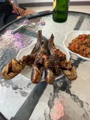 a plate of meat on a table with a bowl of food at \u30d1\u30c8\u30f3\u30eb\u30fc\u30e01 in Patong Beach