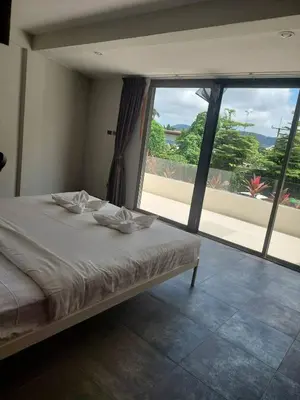a bedroom with a bed and a large window at The green golf resident 106 in Kathu