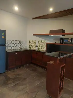 a kitchen with a counter top and a refrigerator at The green golf resident 106 in Kathu