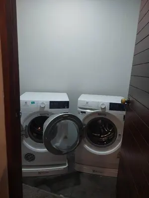 two washing machines sitting next to each other in a room at The green golf resident 106 in Kathu