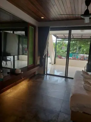 a bedroom with a bed and a large screen tv at The green golf resident 106 in Kathu
