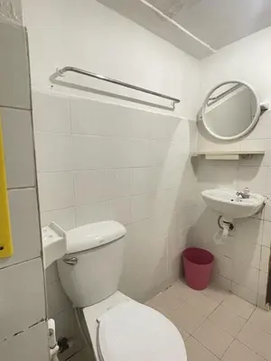 a bathroom with a toilet and a sink and a mirror at Nice to CU Guest house in Patong Beach