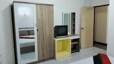 a room with a bedroom with a tv and a mirror at Nice to CU Guest house in Patong Beach