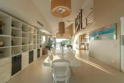 a kitchen with a long white table and chairs at \u82ad\u4e1c\u65e5\u6708\u53cc\u6d77\u666f\u522b\u5885 in Patong Beach