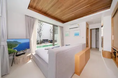 a living room with a large tv and a couch at Sofia Villa Phuket in Phuket Town
