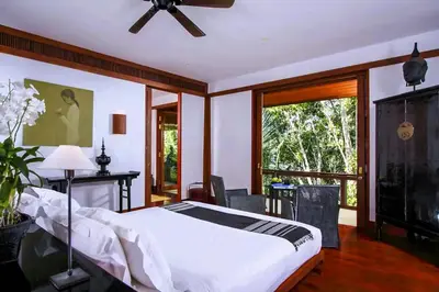 a bedroom with a bed and a ceiling fan at 00 - Thai Paradise on Kamala Bay in Amphoe Thalang