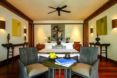 a bedroom with a bed and a table with chairs at 00 - Thai Paradise on Kamala Bay in Amphoe Thalang