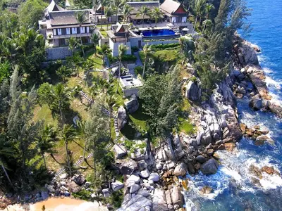 an aerial view of a house on a rocky island at 00 - Thai Paradise on Kamala Bay in Amphoe Thalang