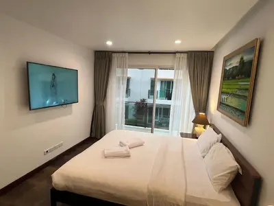 a bedroom with a bed with two towels on it at VILLA AP Grand Residence in Kamala Beach