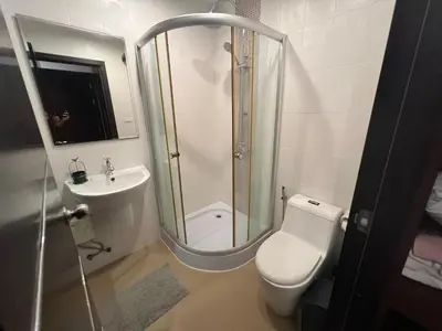 a bathroom with a shower and a toilet and a sink at VILLA AP Grand Residence in Kamala Beach
