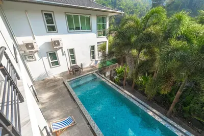 an overhead view of a swimming pool in front of a house at Little Kamala Hill in Kamala Beach