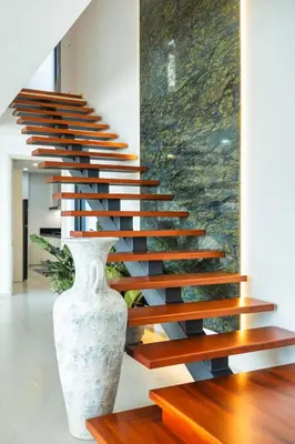 a staircase in a house with a vase at 