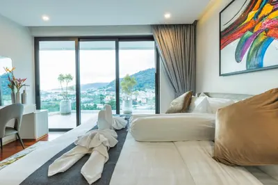 a bedroom with a large bed and a large window at 