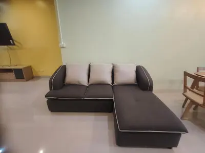 a black leather couch in a living room at Bonanza Patong Beach2 for 2 BR 100m to Beach Grand Room in Patong Beach
