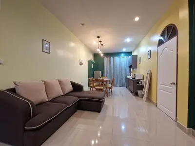 a living room with a couch and a table at Bonanza Patong Beach2 for 2 BR 100m to Beach Grand Room in Patong Beach