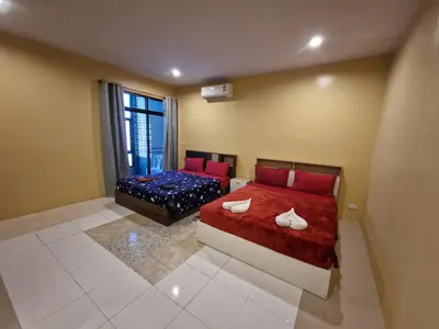 a bedroom with two beds and a window at Bonanza Patong Beach2 for 2 BR 100m to Beach Grand Room in Patong Beach