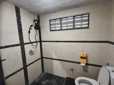 a bathroom with a toilet and a window at Bonanza Patong Beach2 for 2 BR 100m to Beach Grand Room in Patong Beach