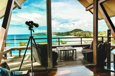 a camera on a tripod with a view of the ocean at 28 - Sea View Luxury Pool Villa in Phuket Town