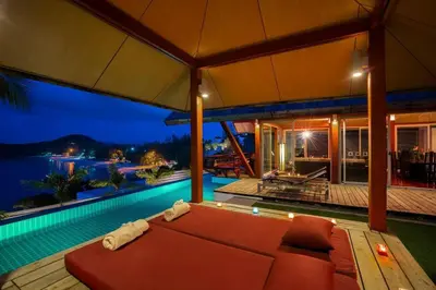 a house with a large bed and a swimming pool at 28 - Sea View Luxury Pool Villa in Phuket Town
