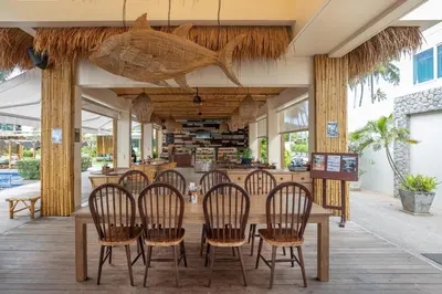 a restaurant with a table and chairs on a patio at Serenity Rawai by Destada in Rawai Beach