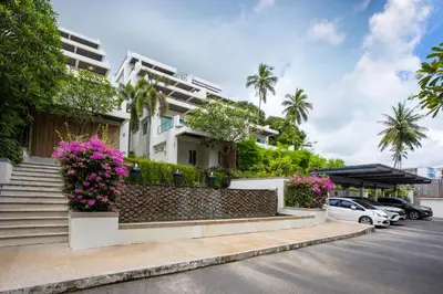 a house with flowers in a parking lot at Serenity Rawai by Destada in Rawai Beach