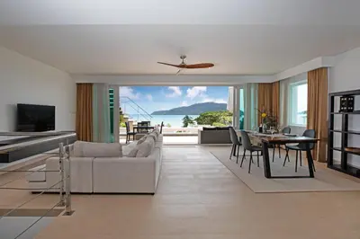 a living room with a couch and a table at Serenity Rawai by Destada in Rawai Beach