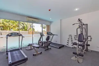 a gym with several tread machines in a room at Chic Condominium Karon B511 in Karon Beach