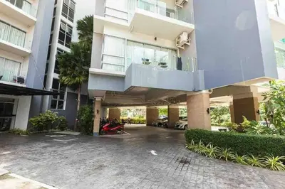 a apartment building with a balcony and a parking lot at Chic Condominium Karon B511 in Karon Beach