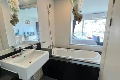 a bathroom with a sink and a large mirror at Chic Condominium Karon B511 in Karon Beach