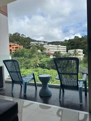two chairs and a vase sitting on a balcony at Chic Condominium Karon B307 in Karon Beach