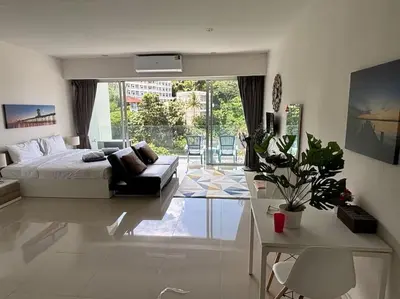 a bedroom with a bed and a couch in it at Chic Condominium Karon B307 in Karon Beach
