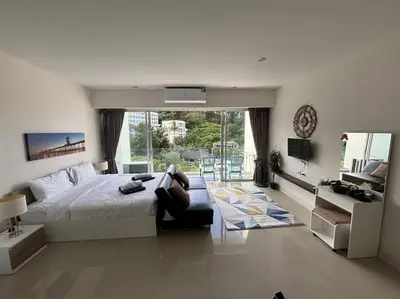 a bedroom with a large bed and a balcony at Chic Condominium Karon B307 in Karon Beach