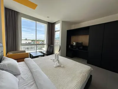 a bedroom with a large bed with a large window at Chill-long inn in Ban Klang
