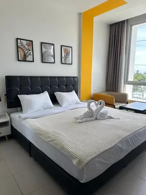 a bedroom with a large bed with two swans on it at Chill-long inn in Ban Klang