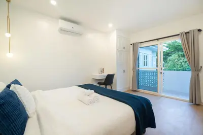 a bedroom with a bed and a large window at Seven Heaven Patong Villa in Patong Beach