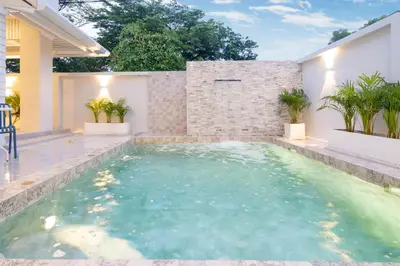a swimming pool in the backyard of a house at Seven Heaven Patong Villa in Patong Beach