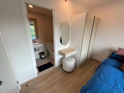 a small bedroom with a bed and a mirror at Phyll Phuket - Luxury Resort-Style Comfort in Ban Rangeng