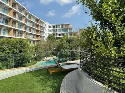 a balcony of a apartment building with a swimming pool at Phyll Phuket - Luxury Resort-Style Comfort in Ban Rangeng