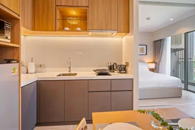a kitchen with a sink and a bed in a room at Laguna Lakeside Residences by Banyan Living in Laguna Phuket